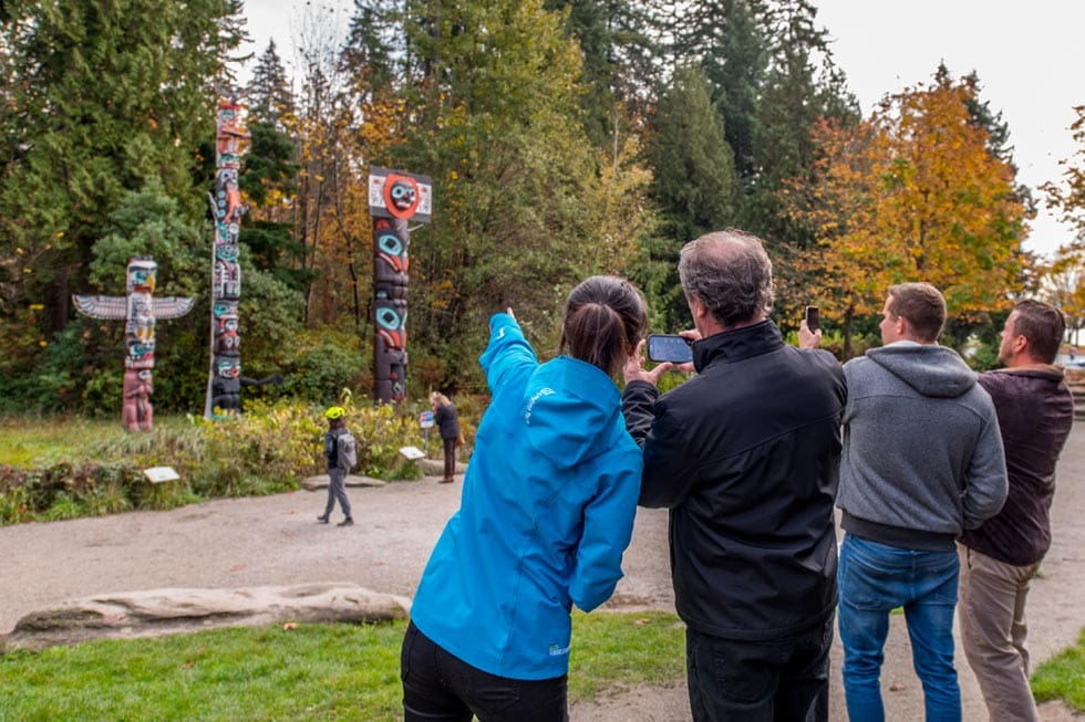 Looking at the Stanley Park Totem Poles- One of the 21 top Tourist Attractions in British Columbia

